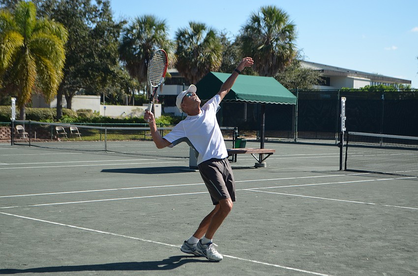 Frank Hagelshaw serves to Joe Bachmann during the men’s 75 singles final match.