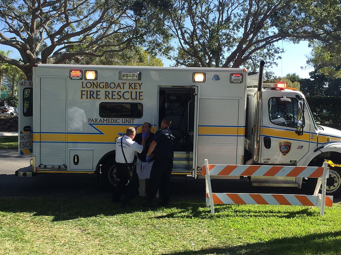 Paramedics inspect and treat a Mar Vista employee following the explosion of a fuel canister at the Kiwanis Club Gourmet Lawn Party on Dec. 3.
