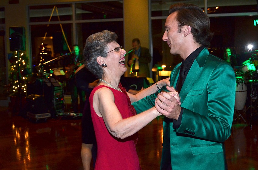 Rose Marie Proietti laughs as she dances with Jacob Hughes.