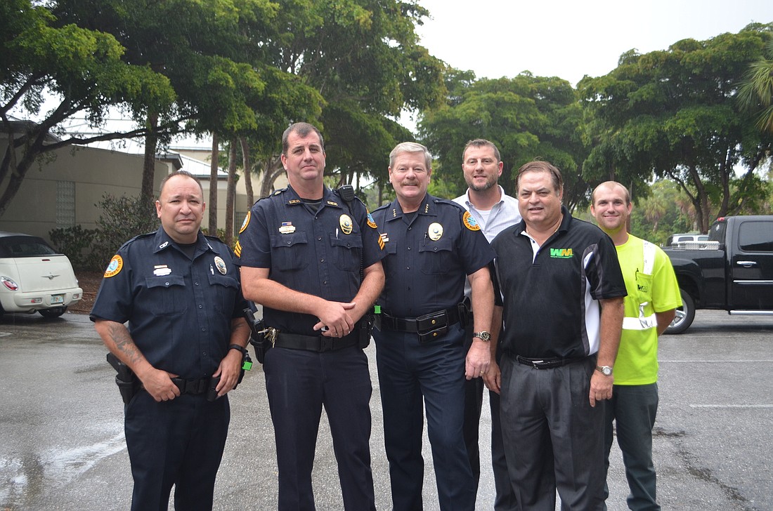 Police Officer Dave Cooper, Sgt. Lee Smith, Police Chief Pete Cumming with Brian Burriss, Bill Gresham and James Dean of Waste Management
