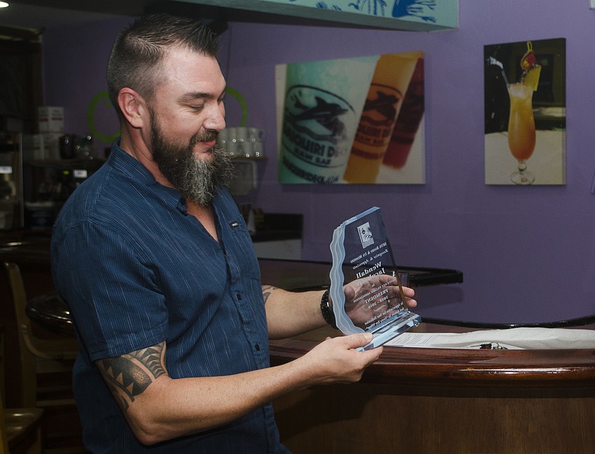 Wendel Jacobson accepts a commemorative award for his time serving as SKVA president.