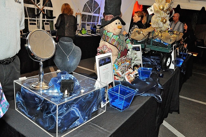 Auction items line the table outside The Grill at O-Bricks.