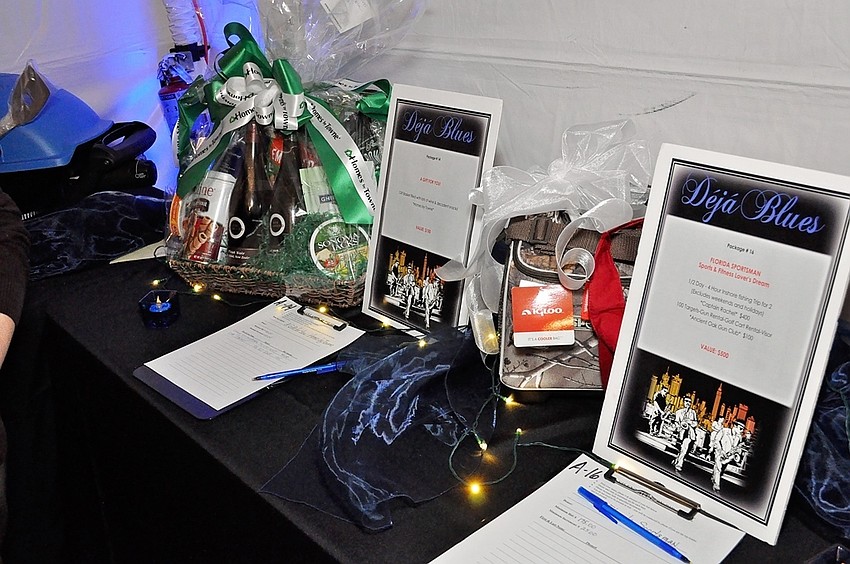 Auction items line the table outside The Grill at O-Bricks.