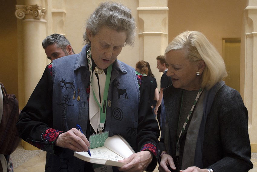 Temple Grandin signs a copy of her book for Marcie Jones.