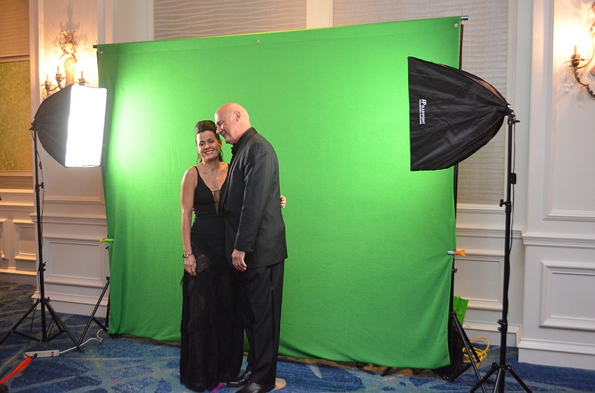 Regina Koda and David Yarletts laugh before posing in the photo booth.