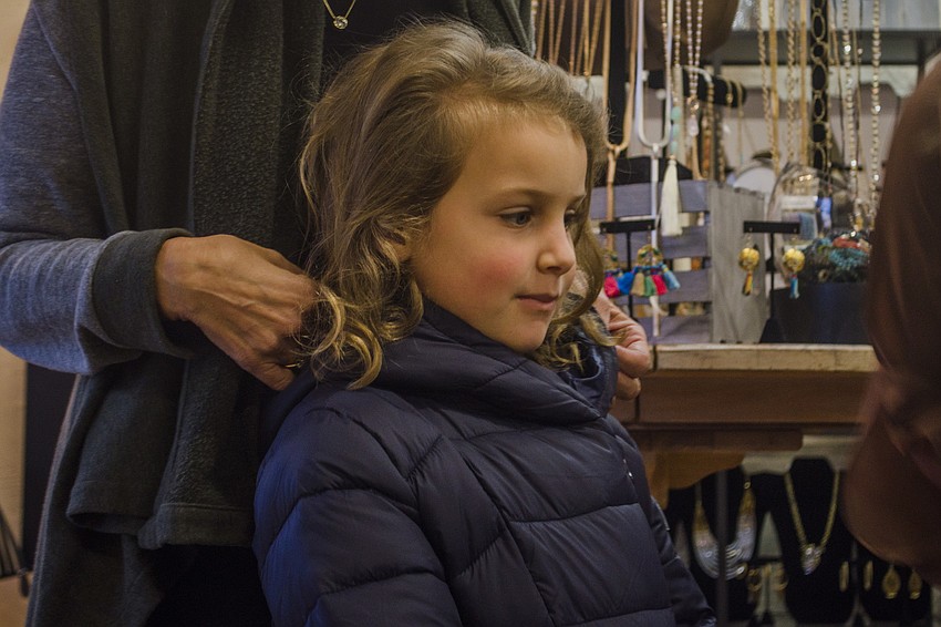 Amara Weiner listens while Nicole Pep-Dorn (not pictured) explains how to participate in the scavenger hunt.