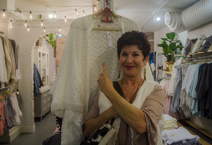 Betty Silverman of Farmhouse Frocks points to the store’s item in the scavenger hunt, hidden among its merchandise.