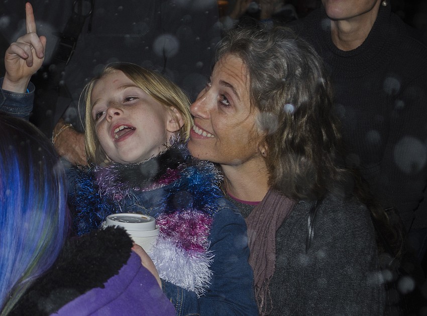 Vivian Dougherty and Cemantha Crain admire the fake snow, which fell during Southside club performances.
