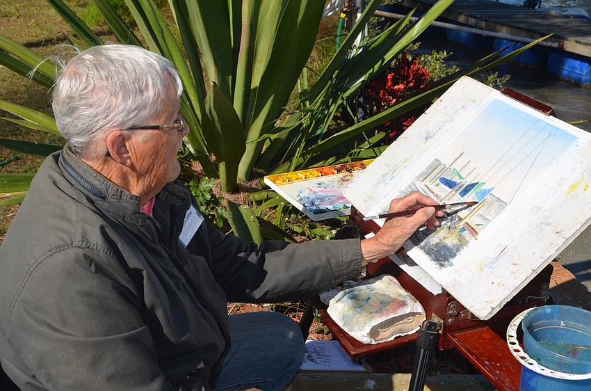 Marilynn Miller paints docked sailboats during “Sail with the Paint Brush,” a fundraising event for the Sarasota Sailing Squadron.