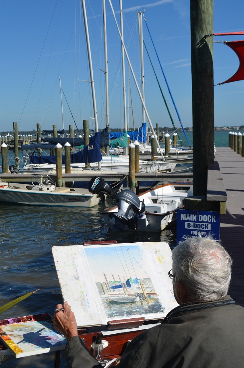 Marilynn Miller paints the boats docked in front of her at the Sarasota Sailing Squadron.