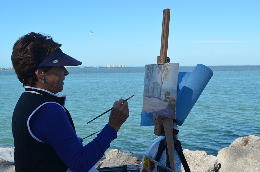 Lynn Wallin paints next to the Sarasota Bay.