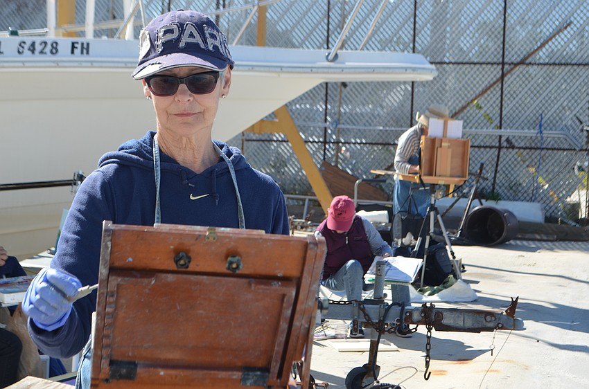 Jane Boyd paints next to fellow SRQ Plein Art painters during a fundraising event for the Sarasota Sailing Squadron.