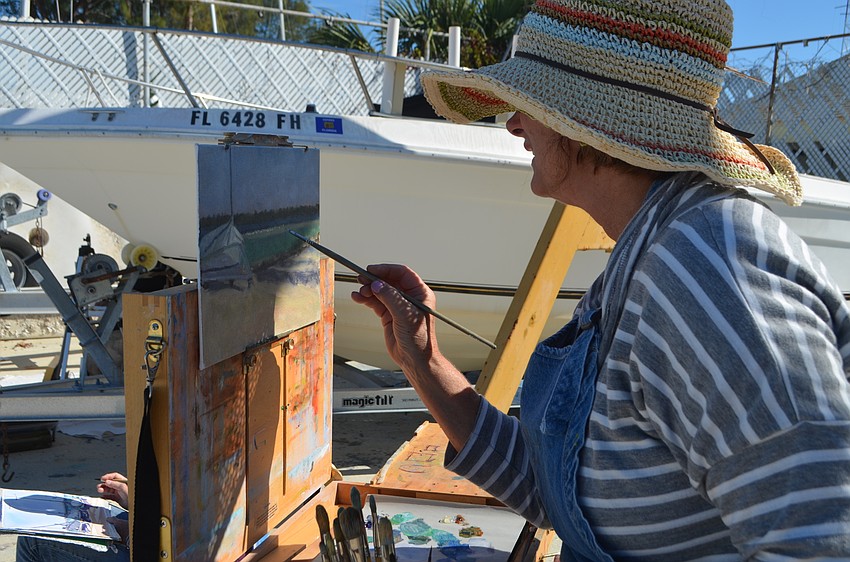 Tish Stanhope concentrates while painting. The SRQ Plein Air painters had two-and-a-half hours to paint a scene around the Sarasota Sailing Squadron.