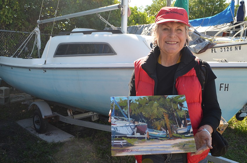 Susan Covert holds her completed painting.