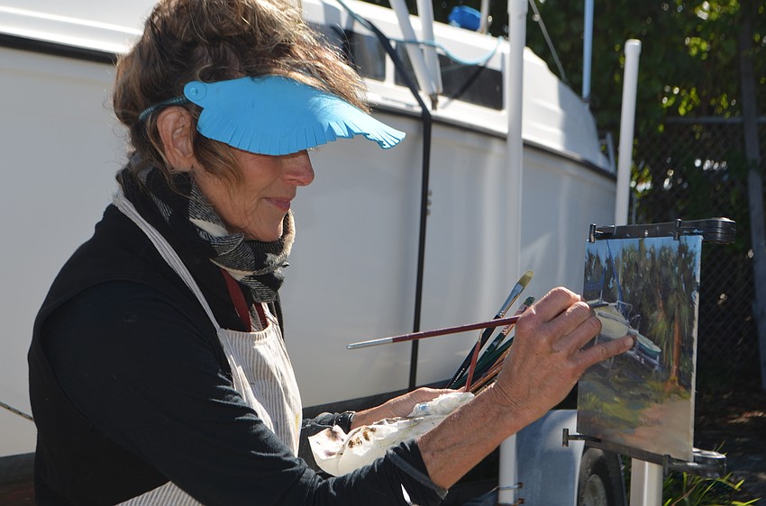 Amy Webber races the clock to finish her painting. The SRQ Plein Air painters had two-and-a-half hours to paint a scene around the Sarasota Sailing Squadron.