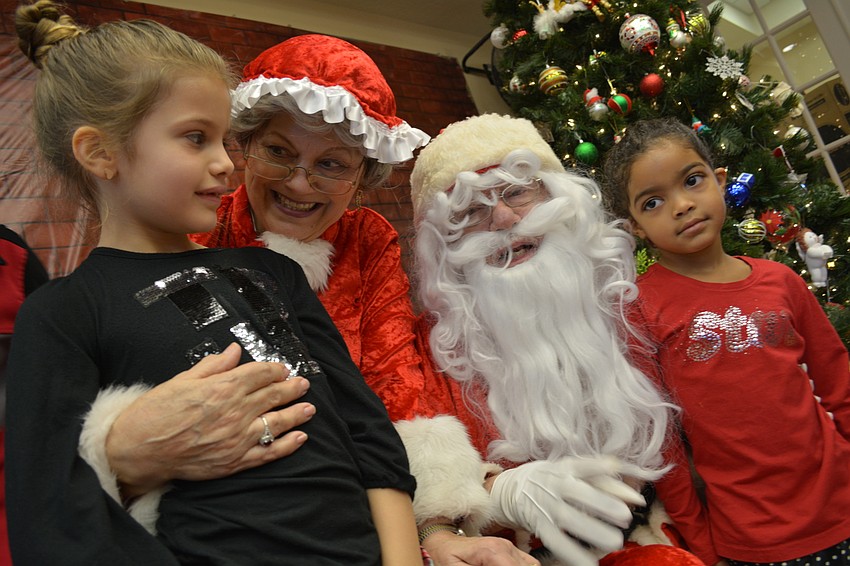 Isabella Strassburg, left, and Lily Strassburg, right, with Mrs. and Mr. Claus (Jeanne and John Larranaga) came with their grandparents, Trish and Scott Drenner.