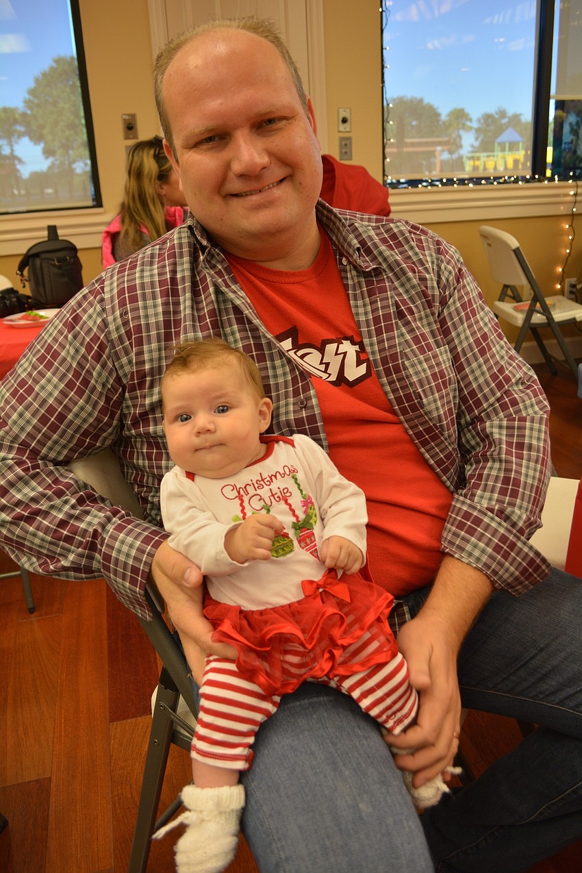 Cliff Chroust  holds his 3-month old daughter, Amelia.