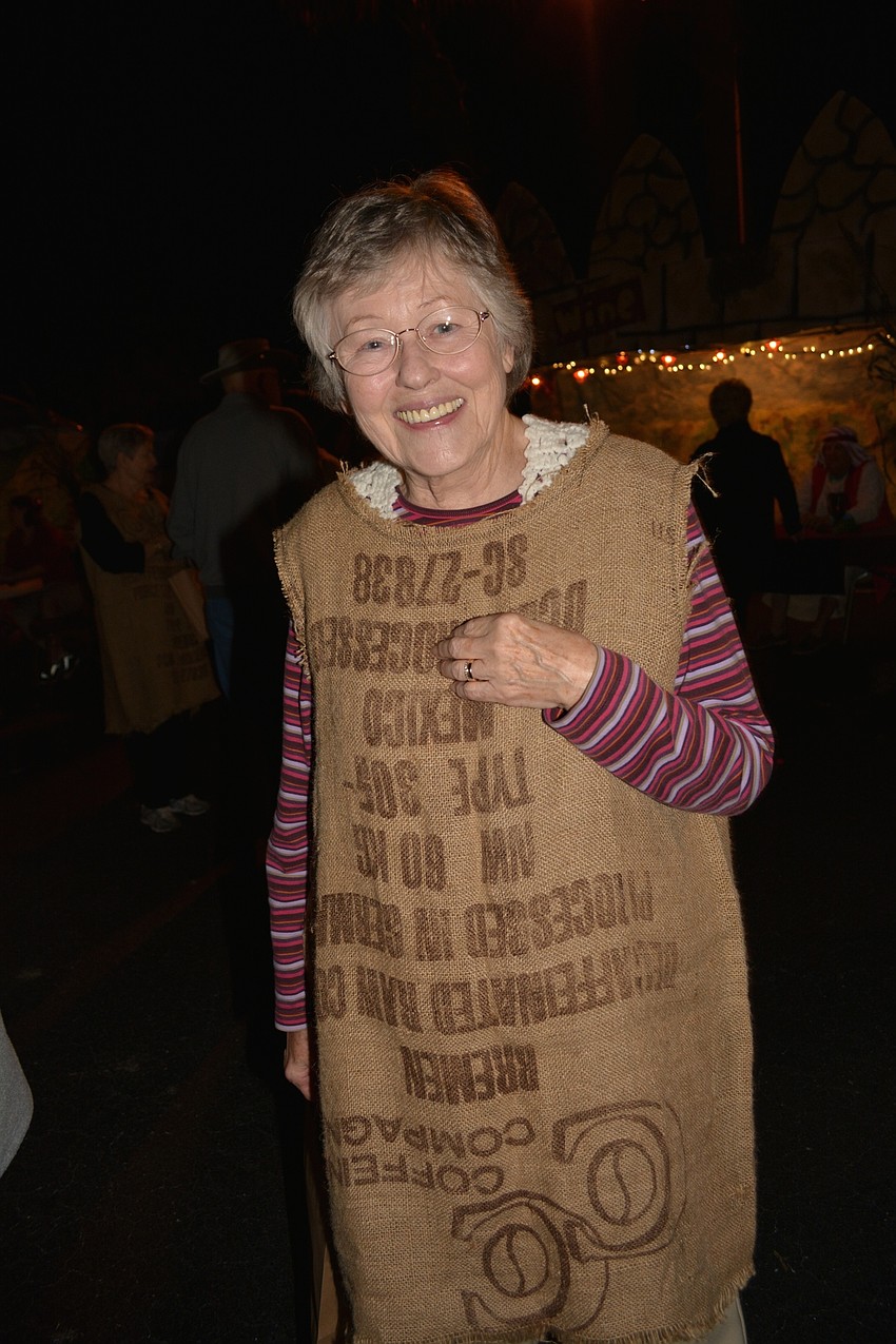 Patty Kunkel acts as a beggar, seeking gold and silver coins from attendees.