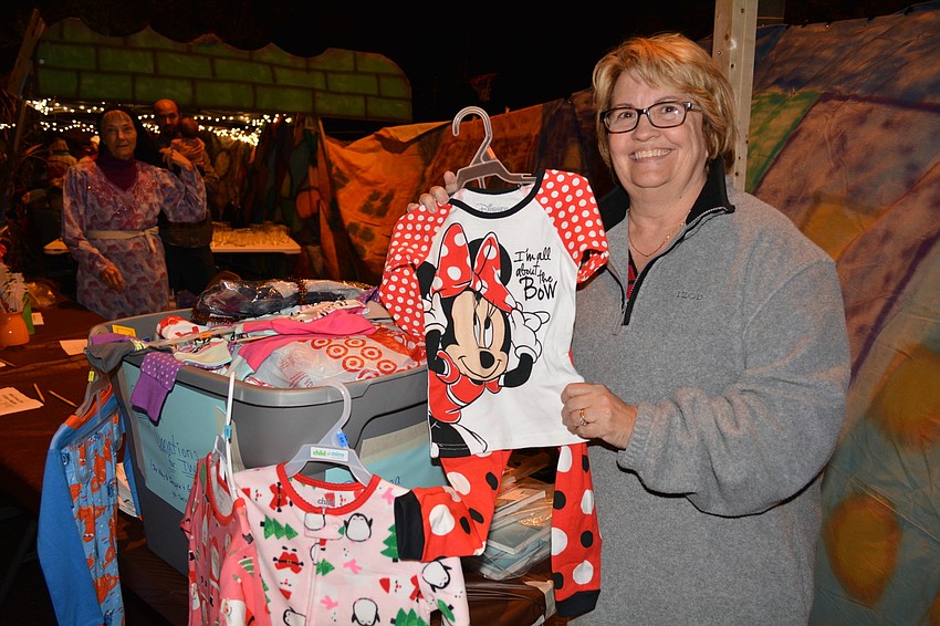 Venice resident Dianne Weed, founder of The Way to Inspire and Give (TWIG), stands with pajamas collected for her organization, which supplies clothes to children in foster care.