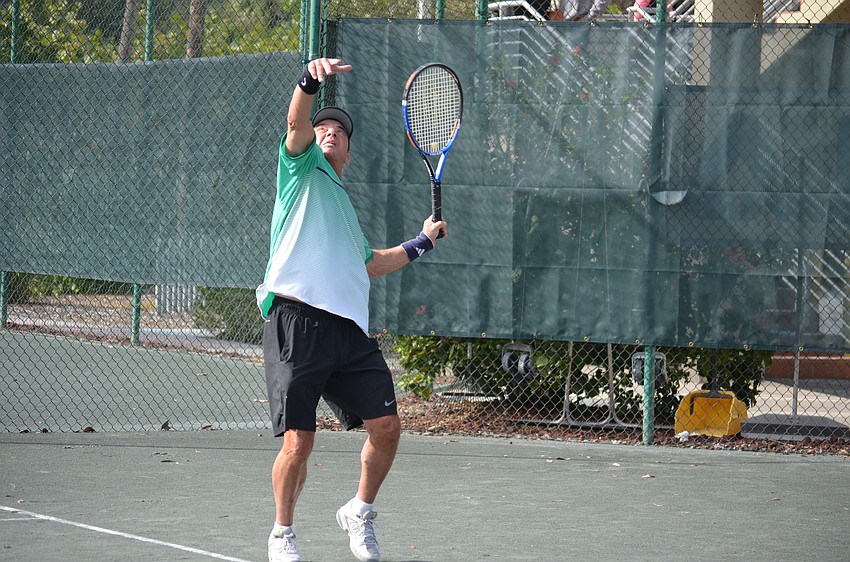 Larry Greenspon serves during a preliminary match.