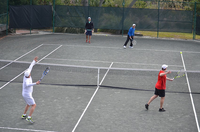 Competitors warm up before a preliminary match on Dec. 9.