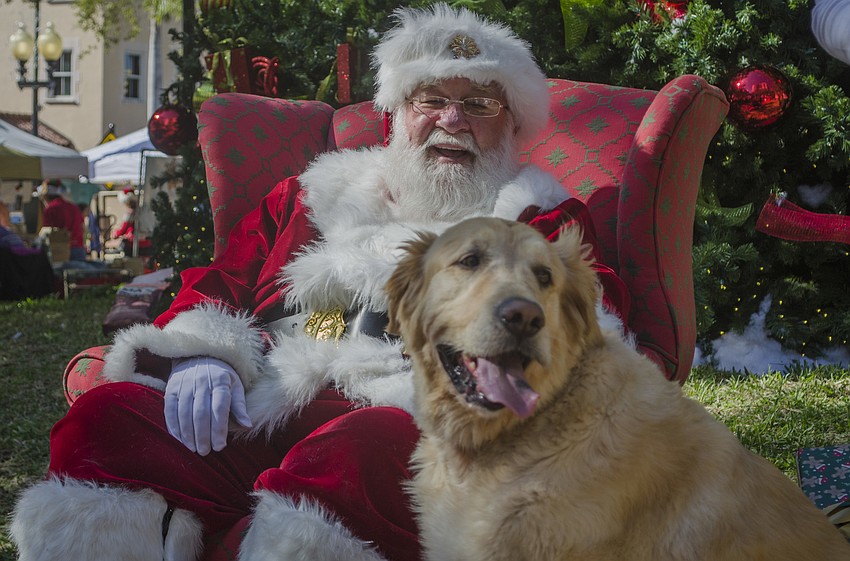Santa pets Gus after posing for a photo.