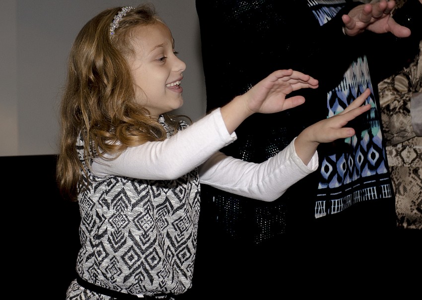 Samantha Arpino mimes a swimming motion to represent the “seven swans of swimming” portion of the “Twelve Days of Christmas.” The audience was split into groups to act out portions of the classic song.