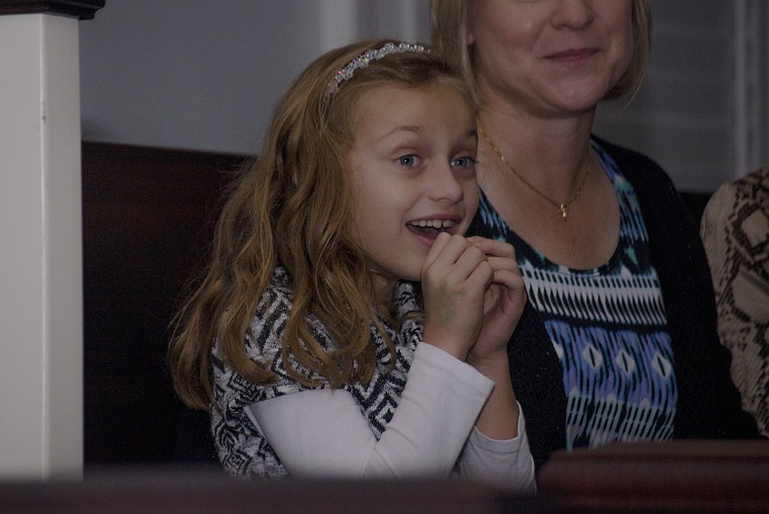 Samantha Arpino gasps as the lights on the singing tree are lit.