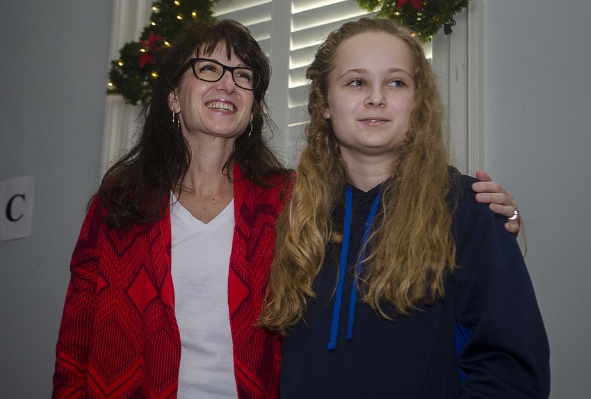 Nicole and Samantha Chaulsett sing Christmas carols.