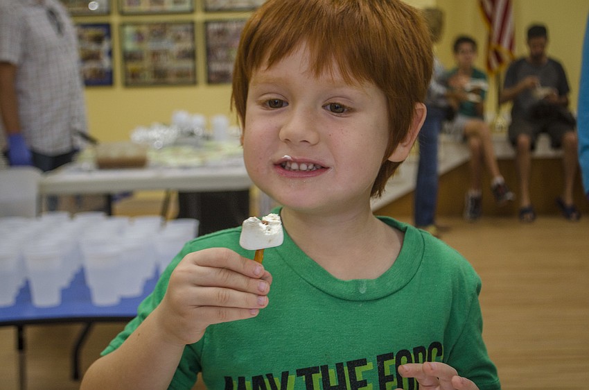 Woody Bryant eats the dreidel he made out of pretzel sticks, marshmallows and chocolate.