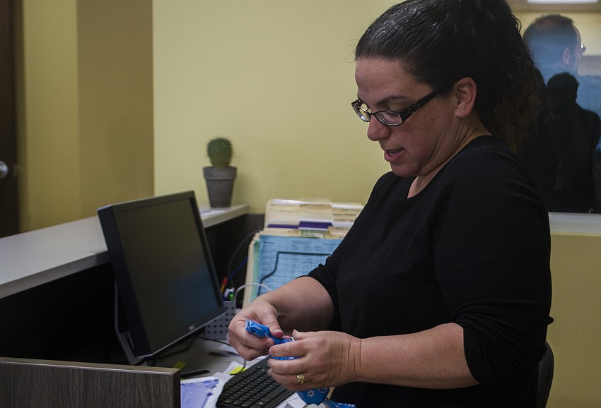 Michelle Pearson wraps a pair of socks for the crazy sock gift exchange.