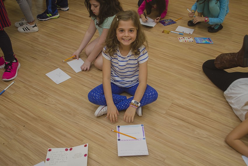 Lanie Fineman writes her own Hanukkah card.