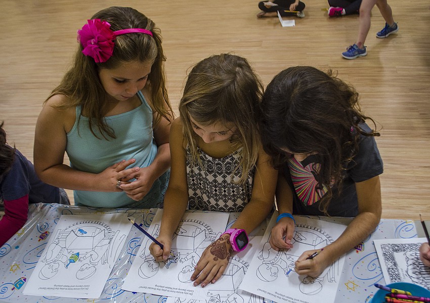 Emma Witherspoon, Dani Mallitz and Ava Rosin color during the craft portion of the celebration.