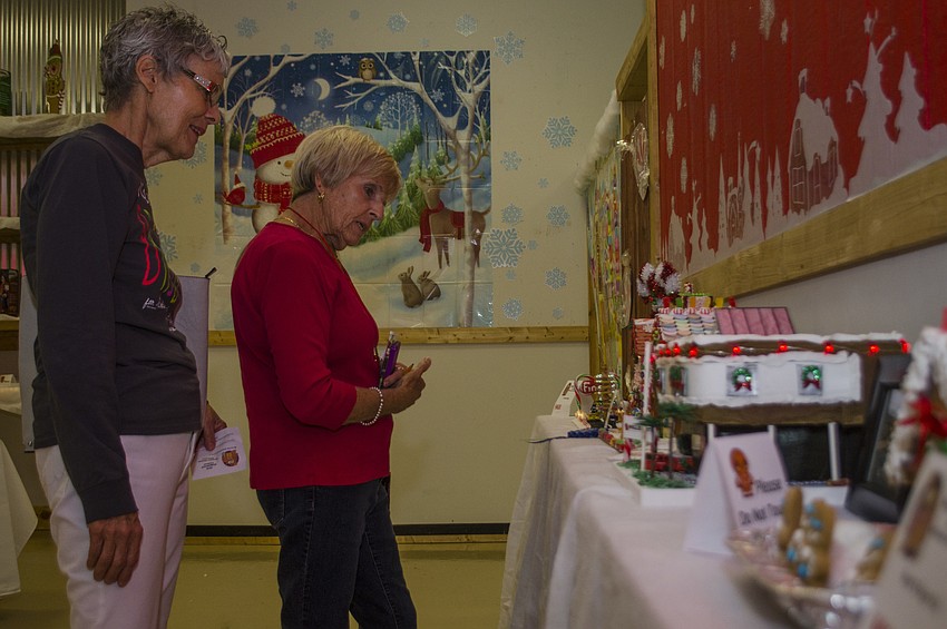 Patti Kelly and Marilyn Kilbride admire the Gingerbread Festival entries.
