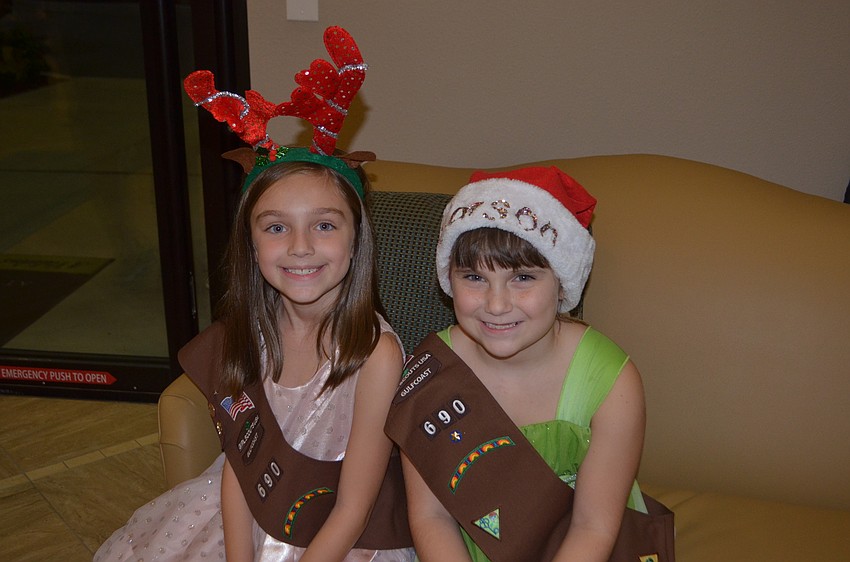 Kaylee Morningstar,7, and Carson Kirkman, 7, sport Christmas headwear.