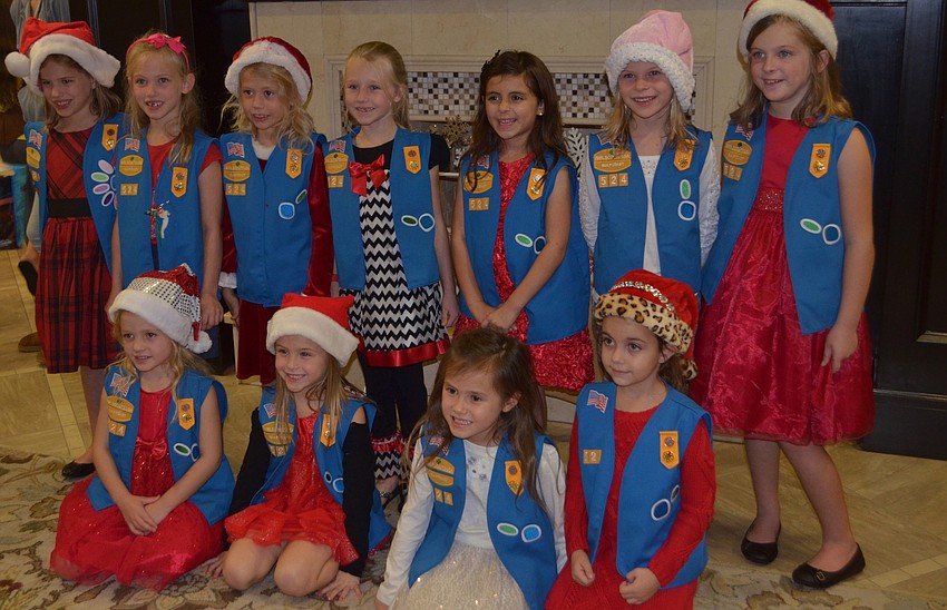 Girl Scout Troop 524 celebrates after singing five Christmas carols.