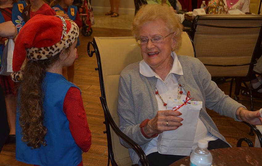 Natalyn Xynidis, of Lakewood Ranch, gives Wanda O'   Rourke a goodie bag.