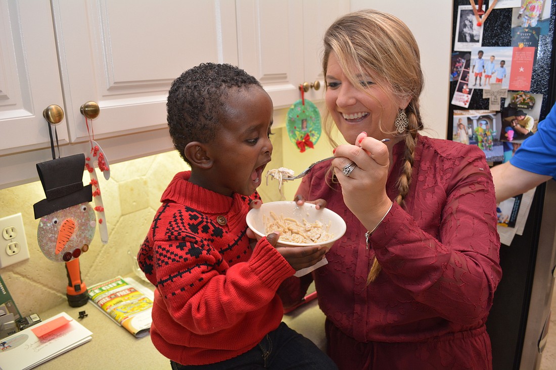 Eyob Fulmer, 3, eagerly eats a bowl of chicken Alfredo, fed to him by his mom, Ashlie Fulmer.