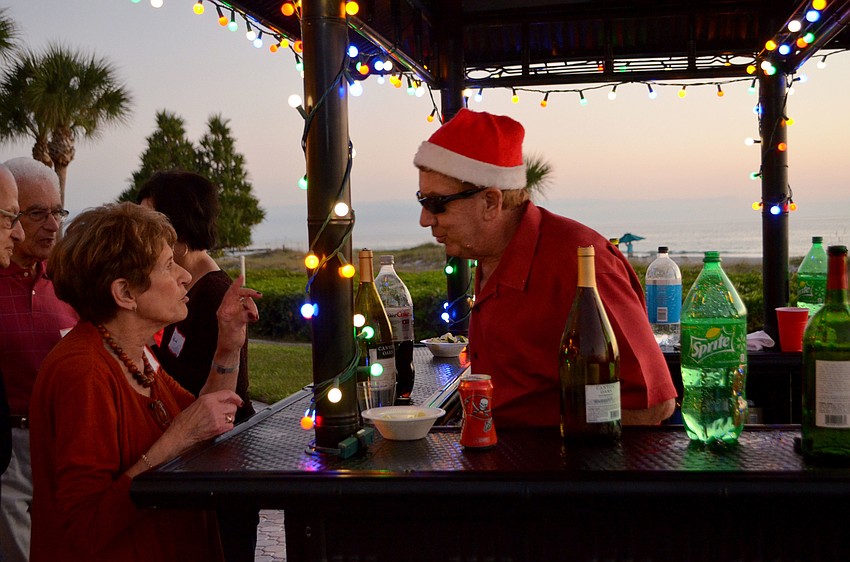 Bill Deskus mans the bar during Seaplace’s holiday party.