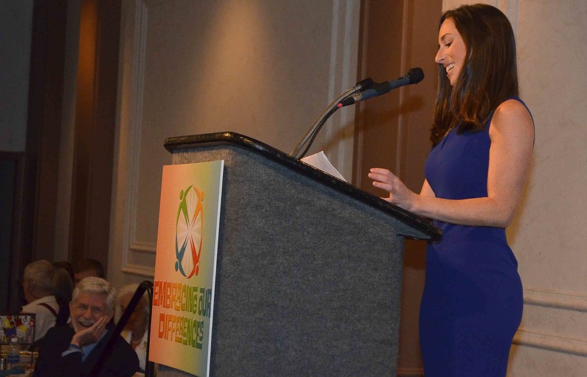 Embracing Our Differences Associate Executive Director Sarah Wertheimer smiles as she addresses the crowd.
