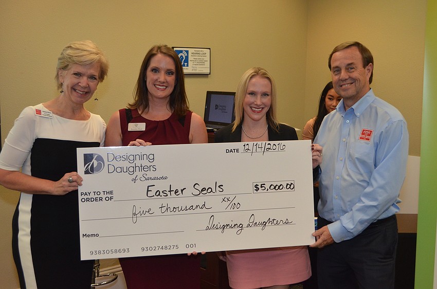 Jannon Pierce, Jen Rust, Lori Hagey and Tom Waters pose with the grant check for Easter Seals.