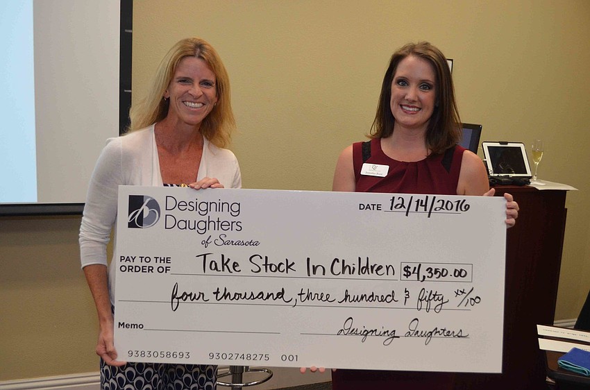 Lisa Bechtold of Take Stock in Children receives a grant check from Jen Rust.