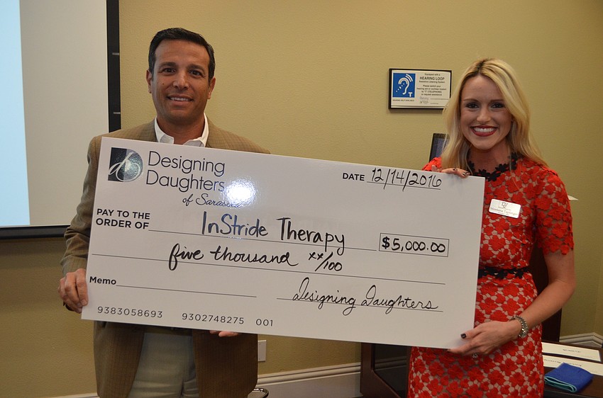 Mark Sultana of InStride Therapy receives a grant check from Montana Taplinger.