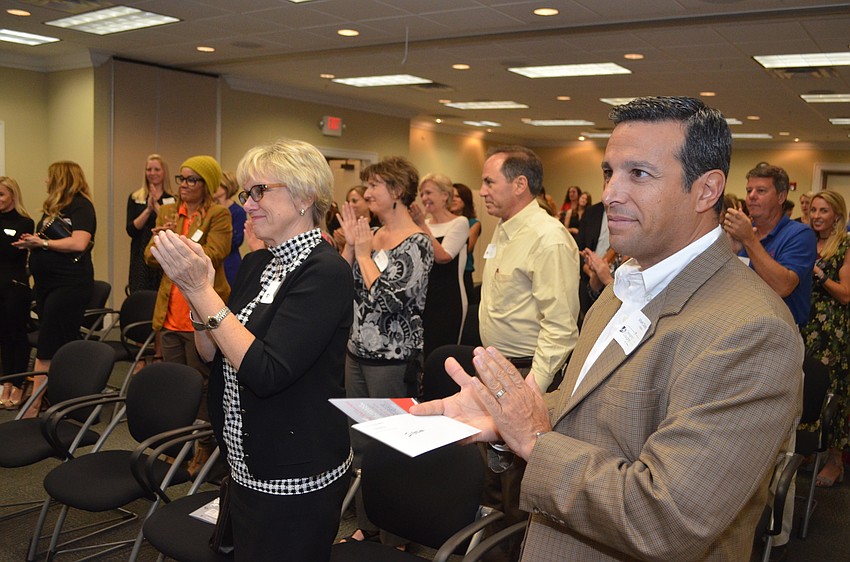Marjorie Floyd, Mark Sultana and the rest of the room clap for the final (and largest) grant given out, $5,000 to Everyday Blessings.