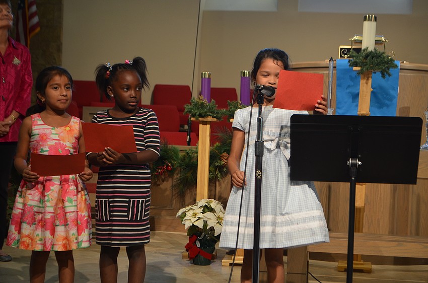 Jonvieve Washington, Jada Snipes and Azuzena Penaloza read “The Carol of the Brown King.”