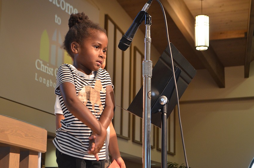 Cristeona Barton reads during the service of Christ Church’s Reading Buddies holiday party.