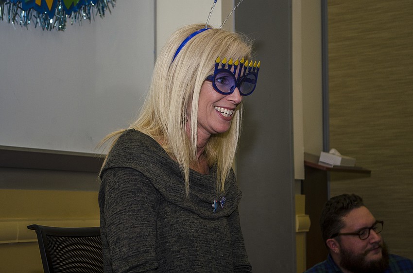 Director of Early Childhood Education at the Gan School at Temple Sinai Laura Freedman wore menorah glasses before she began reading.