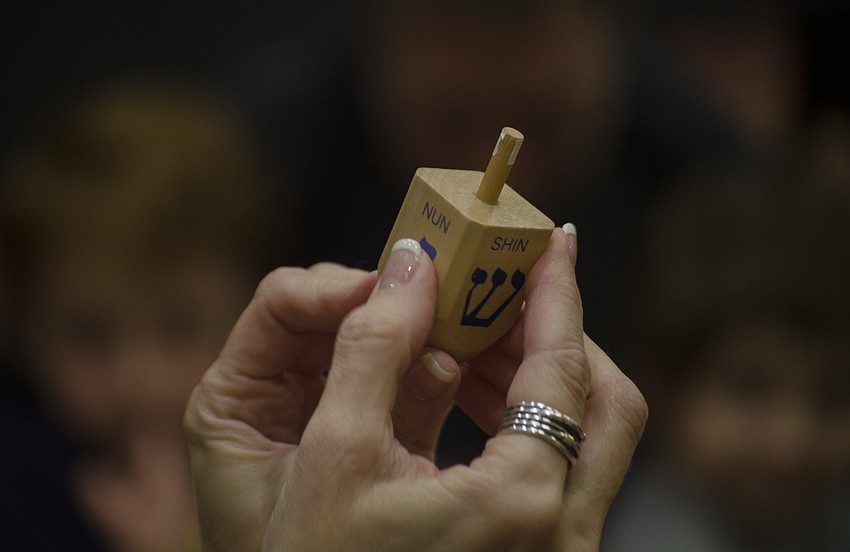 Laura Freedman explains the significance of each of the symbols on a dreidel.