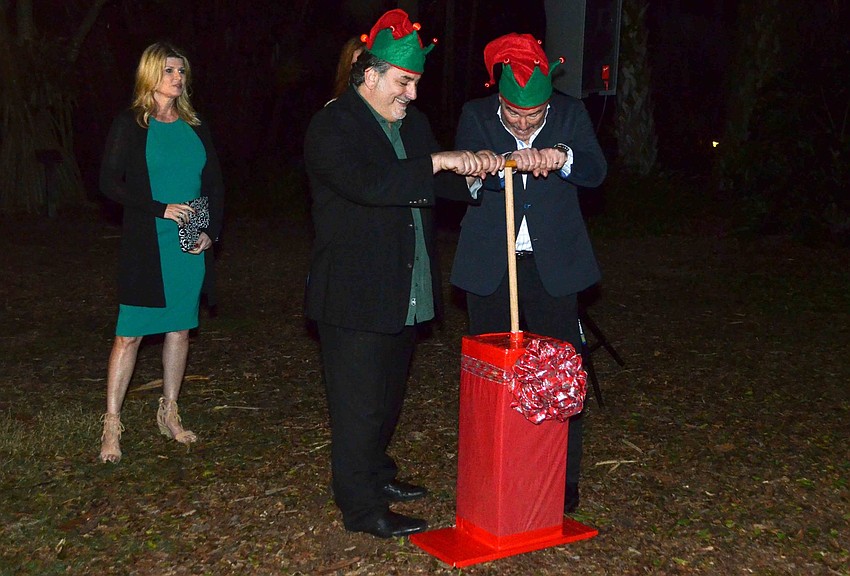 im Mancini and Terri Klauber watch their husbands, Phil Mancini and Michael Klauber, turn on the Christmas lights at Selby.
