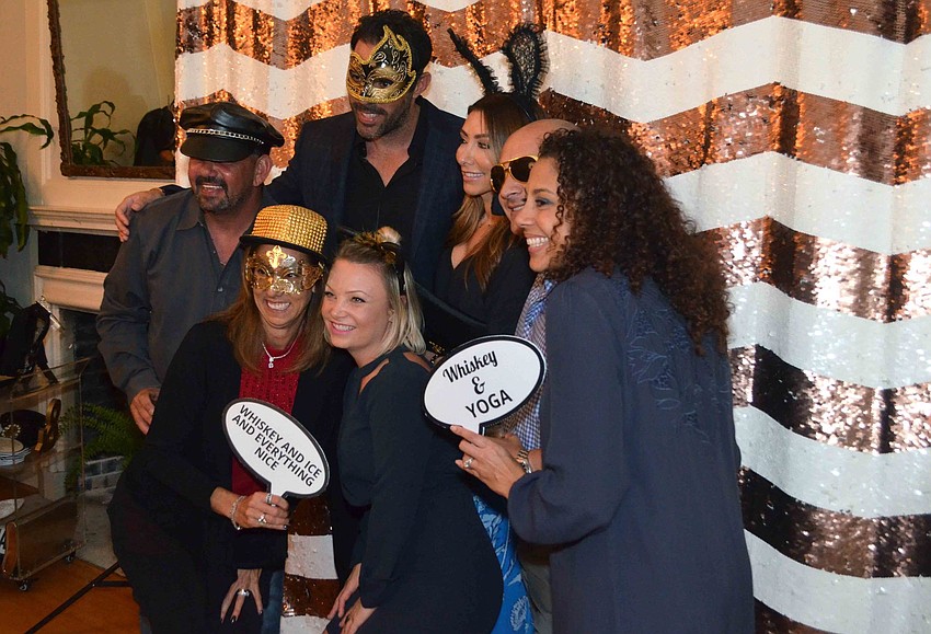 Noel Sparanza, Renier and Michelle Gobea, Jason and Allina Lefrock, Gretchen Sparanza and Chavie Carpenter get their picture taken at the photobooth.